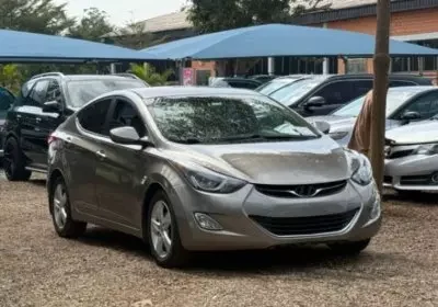 Affordable silver compact sedan parked in a used car dealership, representing budget-friendly cars for first-time drivers in Nigeria.