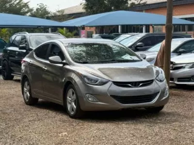 7 Best Budget-Friendly Cars for First-Time Drivers in Nigeria 11 Affordable silver compact sedan parked in a used car dealership, representing budget-friendly cars for first-time drivers in Nigeria.