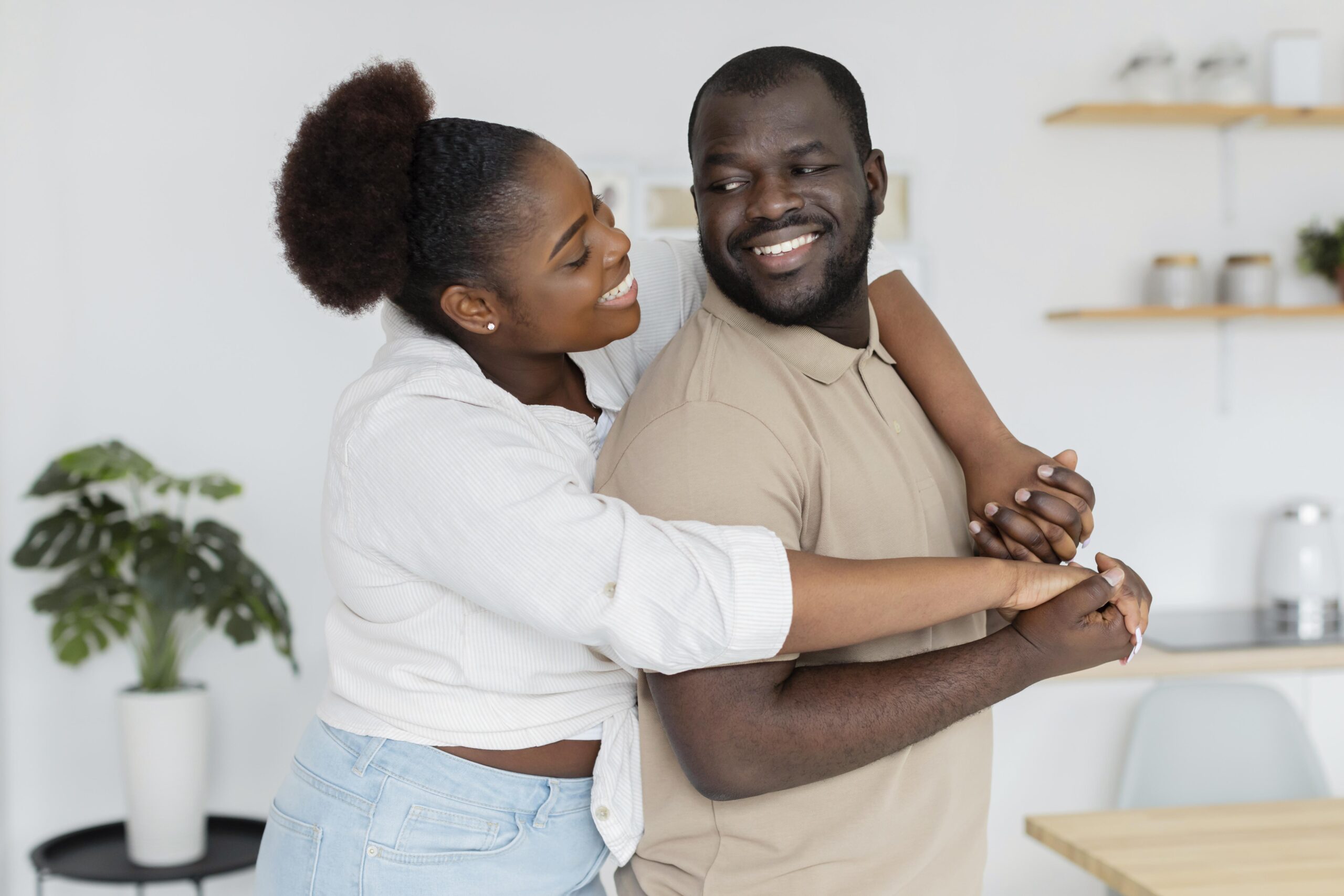 How to Rebuild Trust After a Betrayal in a Relationship 12 Smiling couple embracing at home, symbolizing healing, forgiveness, and rebuilding trust after relationship betrayal.